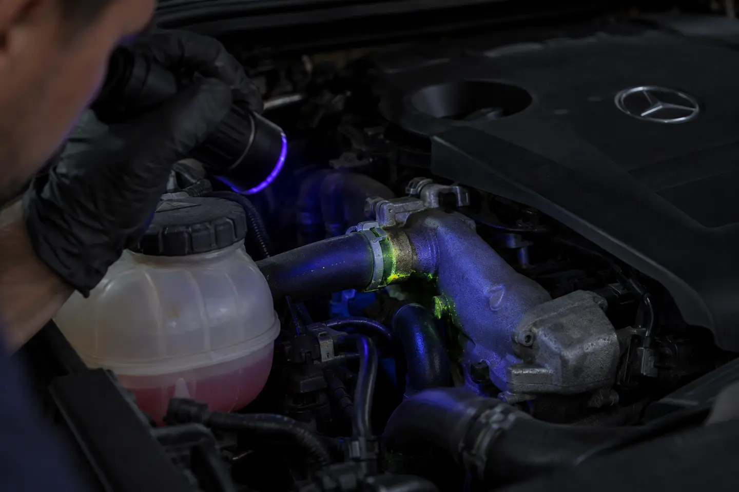 UV dye tracing a hidden Mercedes coolant leak