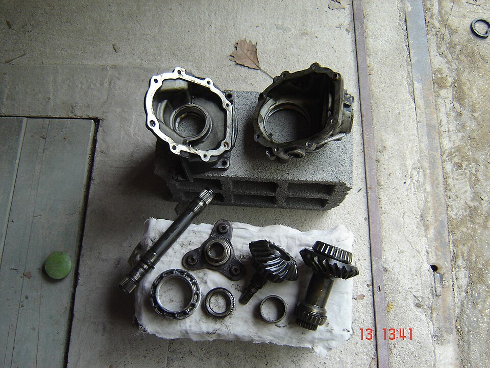 Disassembled differential housing with bevel gears and roller bearings